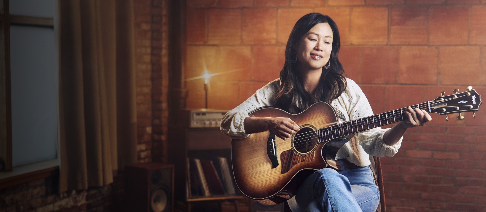 Image of female playing builder's edition guitar